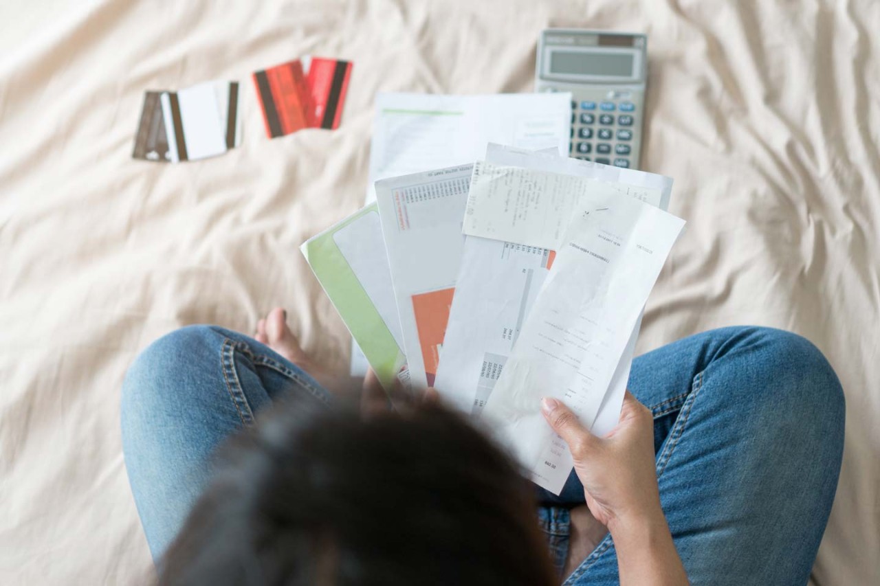 Person looking through many bills